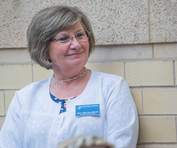 Diane L. Smith, assistant director of nursing, smiles at the remarks offered by nursing alumni.