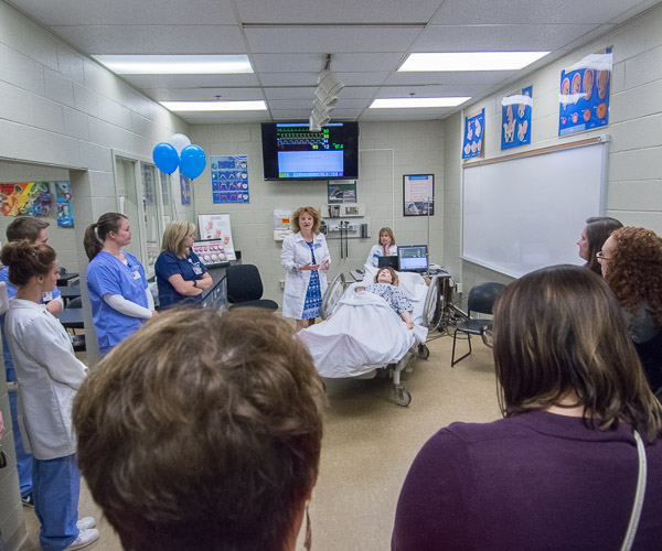 Nursing instructors Dulcey J. Messersmith (standing next to manikin), and Joni J. Pyle (seated), describe how electronic patient simulator SimMom is used to introduce students to complications that may occur during labor and delivery.