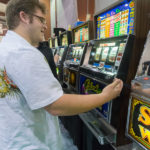 Arden F. Campbell, a culinary arts and system student from Lebanon – and a member of Students of Musical Development (among the night's entertainment) – tries his luck with the slots.