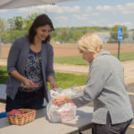 Maria E. Weisser, ShaleNET U.S. data manager, collects nonperishable food and distributes raffle tickets. Prizes included gift cards. theater passes and reserved-parking privileges.