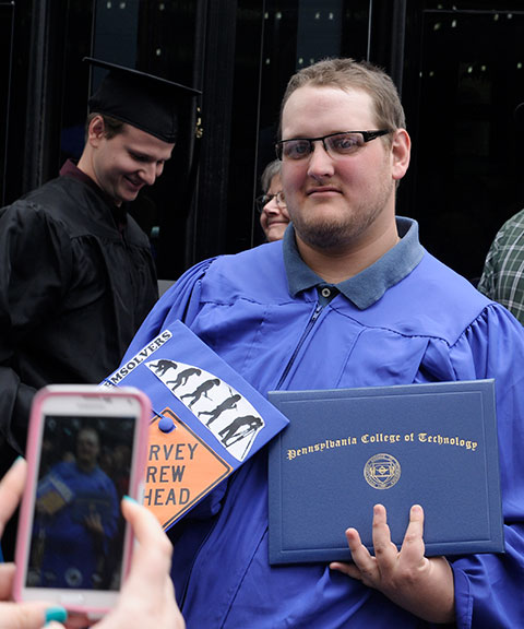 A surveying technology grad shows off his diploma – and whimsically charts the evolution of his chosen career.