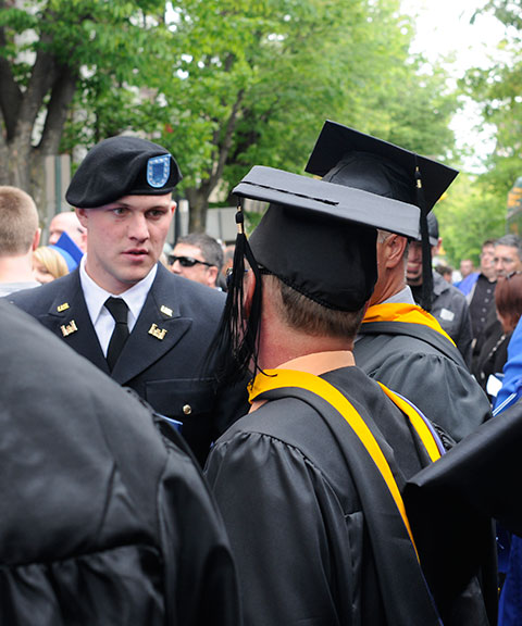 Daniel H. Pulinski, graduating in residential construction technology and management: building construction technology concentration – and commissioned Saturday night as an Army officer – talks with instructors Barney A. Kahn IV (center) and Levon A. Whitmyer. 