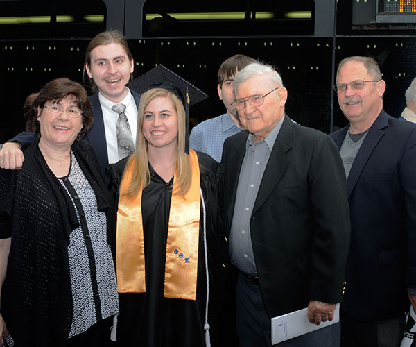 Victoria L. Kostecki celebrates her applied management degree with proud supporters.