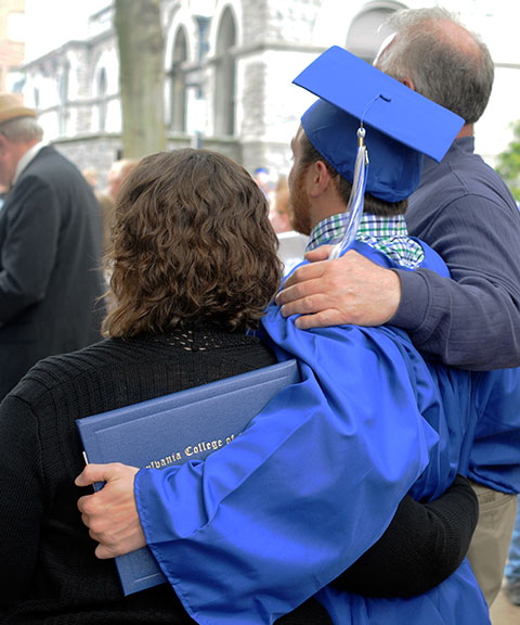 Holding tight to his diploma case ... and to those who helped him get there.