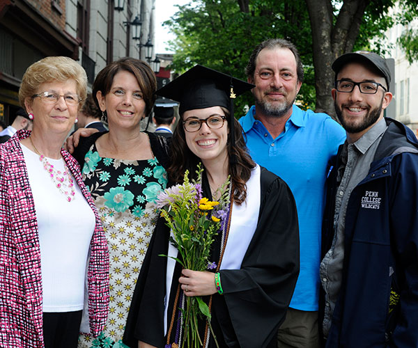 Saturday's afternoon speaker shares her considerable accomplishment with loved ones – Mom Brenda A., among them, who earned a business management degree that day.