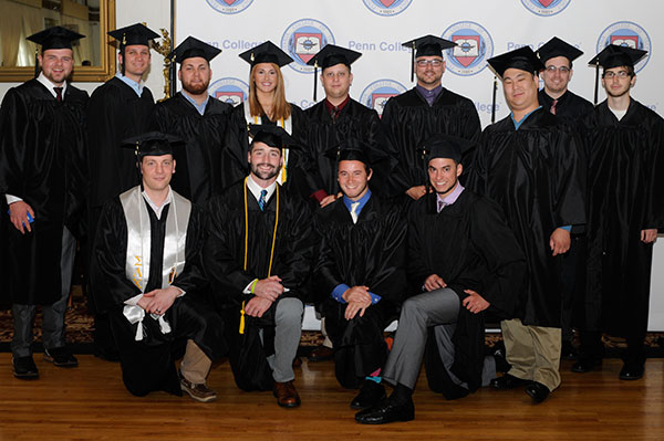 Construction management students make quick work of the logistics involved in a group photo. Third from left in the back row is Anthony V. Rode, recipient of the Construction Management Faculty Award.