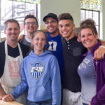 Barbara K. Emert-Strouse (right), and her family, including May culinary arts and systems graduate Scott L. Neff (with hat), join forces in the kitchen of Christ Episcopal Church in Williamsport to serve a free meal to the community.