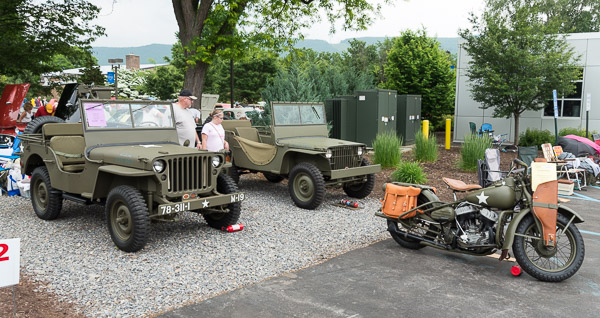 Two Jeeps and a Harley-Davidson, all from the World War II era, pose a triumvirate of tribute to the military.