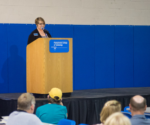 Debra M. Miller, Penn College's vice president for institutional advancement, greets Friday's Field House audience ... 