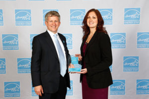 Alison A. Diehl, director of Penn College’s National Sustainable Structures Center, accepts The Northwest Energy Efficiency Council Energy Star award from Jacob Moss, deputy director of the EPA Climate Protection Partnerships Division. (Photo provided)