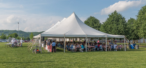 The campus' V.I.P. visitors gather under tents Friday for a picnic on the intramural field.