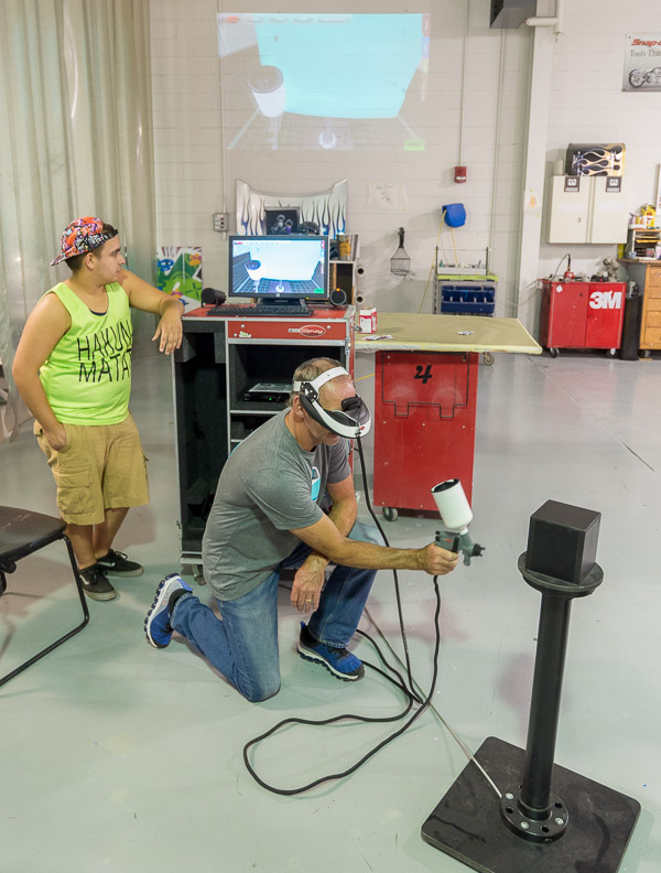 Raymond J Wotkowski, of Sidman, tries out a virtual sprayer during a paint simulator workshop in College Avenue Labs.