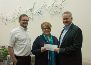 Debra M. Miller, Penn College’s vice president for institutional advancement, accepts a check for The Witmer Group Scholarship from Roger Derr (left), senior vice president-masonry restoration, and Ken Schwebel, company president.