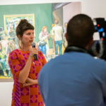 The artist talks with gallery patrons.