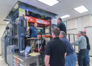 Christopher J. Gagliano (left) leads workshop attendees on a tour of the Plastics Innovation & Resource Center's Thermoforming Center of Excellence.