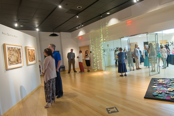 Gallery visitors engage in art and expression.