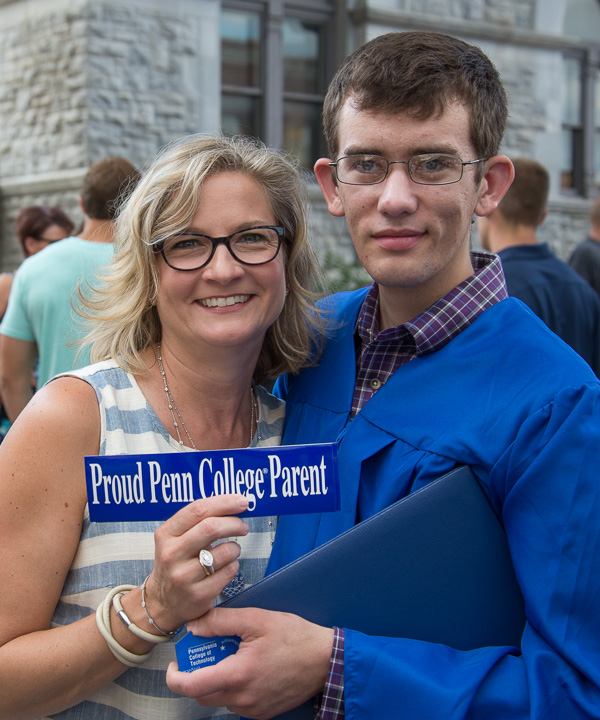 Automotive technology graduate Claude T. Dickinson IV shares a proud moment with his mother, Kathy.
