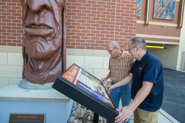 Stabley (background) and Flynn relive their recovery work through a commemorative marker.