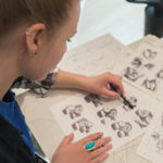 Graphic design student Ainsley R. Bennett adds shadow to a still-life sketch. Hand-drawing skills remain important in the college’s graphic design and advertising art majors.