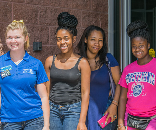 Penn College's Cassandra D. Henderson (left) greets new members of the campus family.
