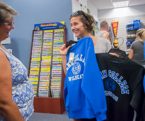 Hillary Newlin gets some help choosing among sweatshirts in The College Store ... an in-demand item for Pennsylvanians who know it won't stay 90 degrees for long.
