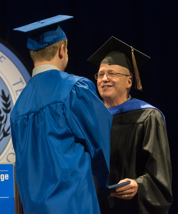 Conor D. Flynn, who graduated in radiography, is congratulated by his father, Brian A., an assistant professor of graphic design.