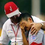Team "Uncle" Marlin R. Cromley reassures Japan's Rio Inoue after the team's 2-1 loss to Curacao on Saturday.