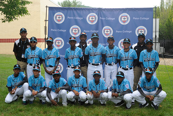 The Caribbean champs, from Pariba Little League in Willemstad, Curacao, pose for a team photo before a Penn College backdrop.