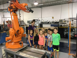 Children tour the automated manufacturing lab, where Penn College students use industry-standard equipment to prepare them for careers in manufacturing engineering.