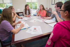 Some of the students in the Community and Organizational Change course discuss logistics in support of the Community Challenge. From left are Holly N. Engel, Montoursville; Sabrina A. Schubert, Clarks Summit; Brooke L. Gray, Muncy; Mandy M. Myers, Duke Center; Travis R. Neyhart, Jersey Shore; and Tierney N. Lookingbill, York. All of the students are enrolled in the applied human services major. 