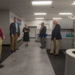 Shawn A. Kiser (left), director of dental hygiene, leads the group – which includes Paul L. Starkey (second from left), vice president for academic affairs/provost – through the newly renovated clinic.