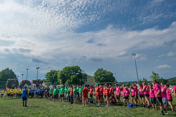 Teams line up under a Wildcat-blue sky.