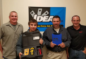 Electrical technology major Joseph L. Brubaker, of Port Trevorton, displays the digital multimeter he earned for recording the fastest time during the recent IDEAL National Championship qualifying event at Penn College. With Brubaker (from left) are: Eric W. Newcomer, electrical technology/occupations lecturer at the college; James Knight, of IDEAL; and Nick Smith, of Schaedler Yesco. (Photo by Jon W. Hart)