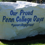 Adorned with lyrics from the college alma mater, a landmark stands ready for weekend photo ops.
