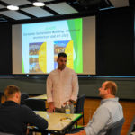 Travel to Europe and the United Kingdom to explore "Sustainable Building and Design" is explained by faculty member Naim N. Jabbour. Talking with the assistant professor of architectural technology are Andrew J. Davies (left), of Lititz, and Adam T. Knoebel, of Montoursville, both majoring in building science and sustainable design: architectural technology concentration.