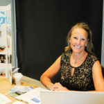 Part-time dental hygiene instructor Rhonda J. Seebold is on hand to talk with eligible students about boosting oral hygiene for schoolchildren and families in the Dominican Republic.