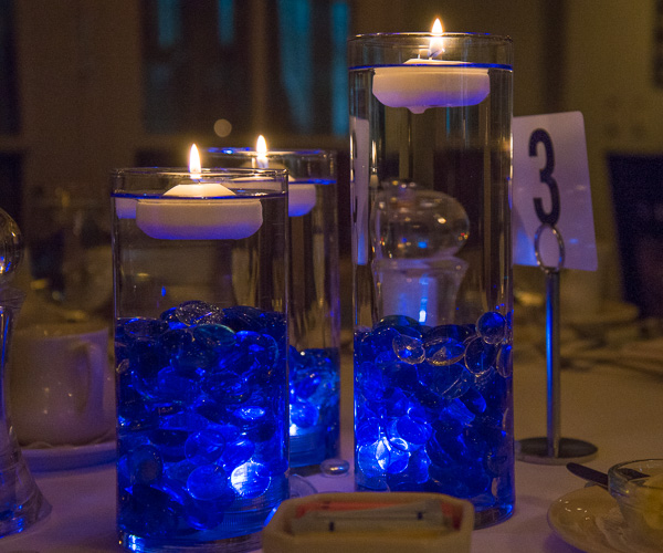 Glowing centerpieces in Wildcat blue, a special touch by April M. Yancey, secretary/receptionist for athletics, adorn the Hall of Fame banquet tables.