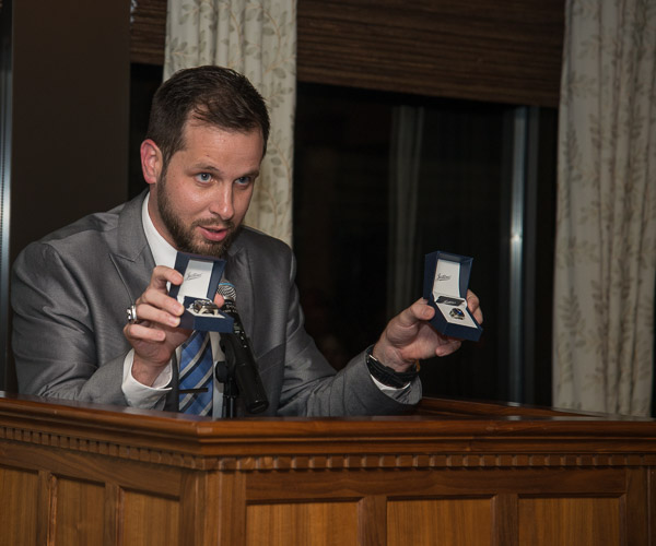 Showing off the new Hall of Fame rings is Matt Blymier, assistant director of athletics/sports information director, who coordinated and emceed the banquet. 