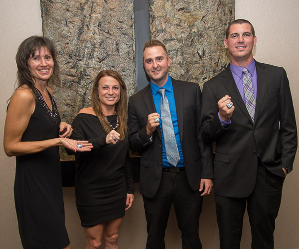The 2016 inductees to the Athletic Hall of Fame – (from left) Bambi Hawkins, Tamara Pavlov, Craig Flint and Greg Solyak – strike a winning pose with their new Wildcat bling. (Honorees had their choice of a ring or necklace pendant.)