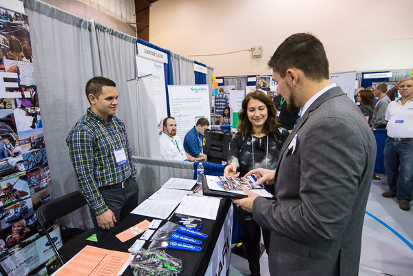 Joel M. Papu (left), an automotive alumnus twice over, shares information about Subaru of America.