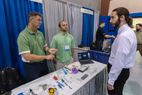 Lucas R. Lorson (center), a 2008 graduate in plastics and polymer technology, returns to campus with co-workers from Carclo Technical Plastics, Latrobe.