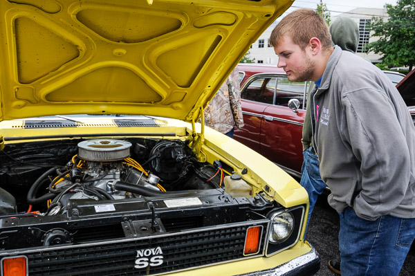 Mitchell J. Berninger, a web and interactive major and member of the Phi Mu Delta brotherhood, checks out an entry at the fraternity-sponsored car show. 