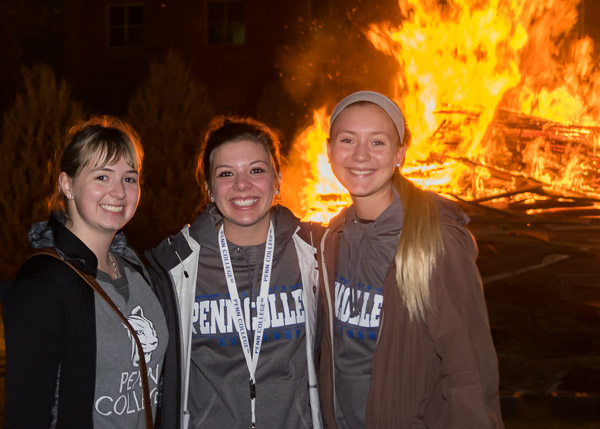 Framed by flames are (from left) Samantha K. Steiger, Emily R. Sillaman and Libby M. Gingrich, all majoring in pre-dental hygiene.