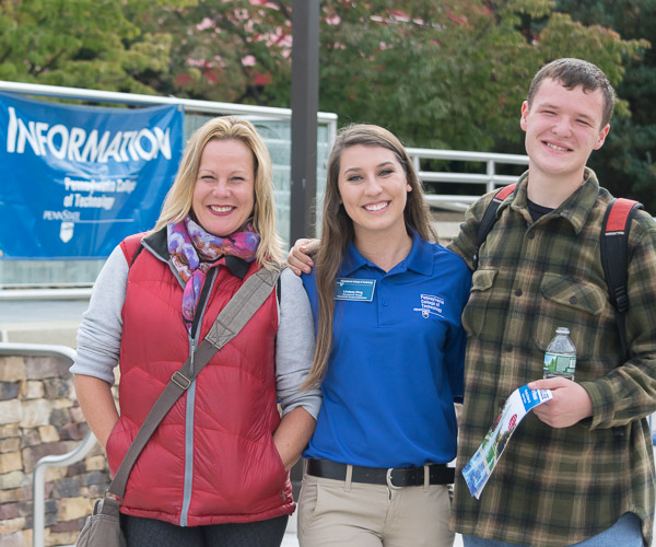 Student Ambassador Lindsey A. King joins a mother and son on their get-acquainted tour of campus.