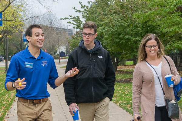 Ryan Monteleone, among the college's student ambassadors, leads a tour with typical enthusiasm.