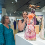 Patrons marvel at the creativity and variety of the pieces on display.