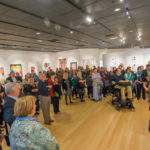 An attentive crowd listens to the "Artists' Talk" during a rare Saturday opening reception.