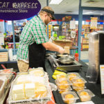 Dining Services Manager Christopher R. Grove staffs a made-to-order station, specializing in gourmet grilled sandwiches.