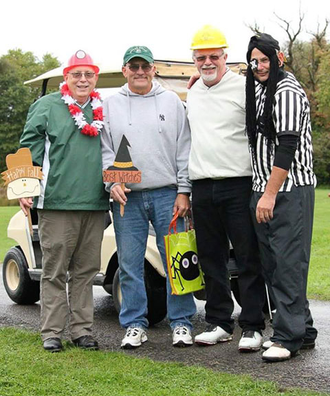 Alums Jeffrey Benko and Timothy Swank, along with two friends, were good sports at the dress-up hole.