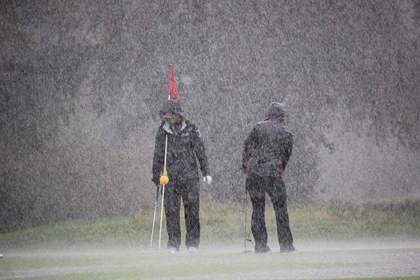 Determined to finish out the hole, these women persevered in near-horizontal rain at White Deer Golf Course.